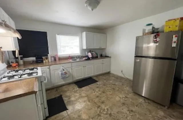 a view of a livingroom with furniture and a flat screen tv