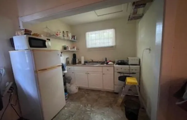 a front view of a house with a fence