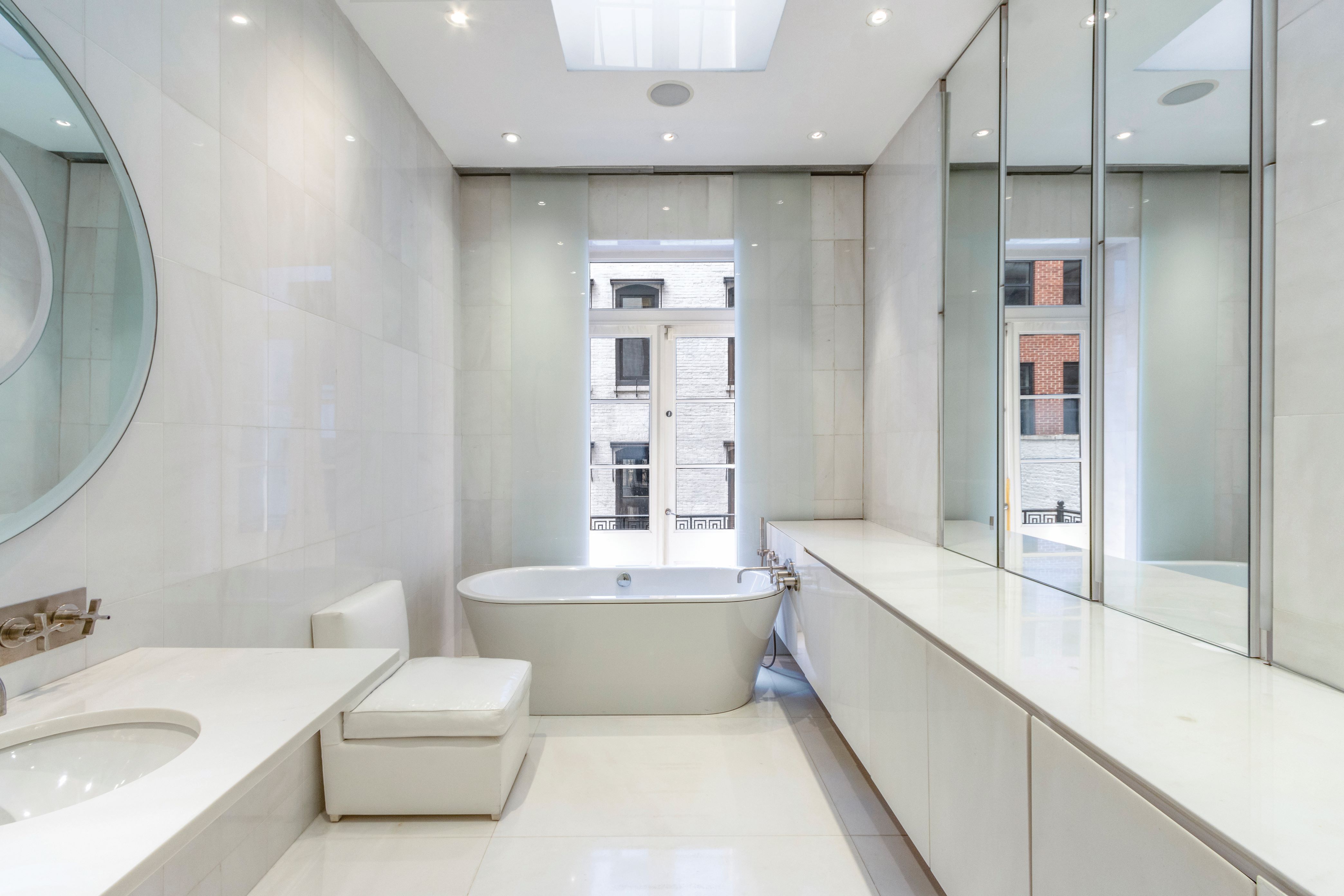 36 East 63rd Street Manhattan, NY 10065 - Photo 14 of 21 a bathroom with a double vanity sink mirror and bathtub