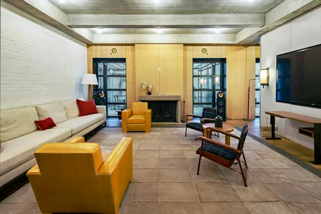 a living room with lots of furniture and a book shelf
