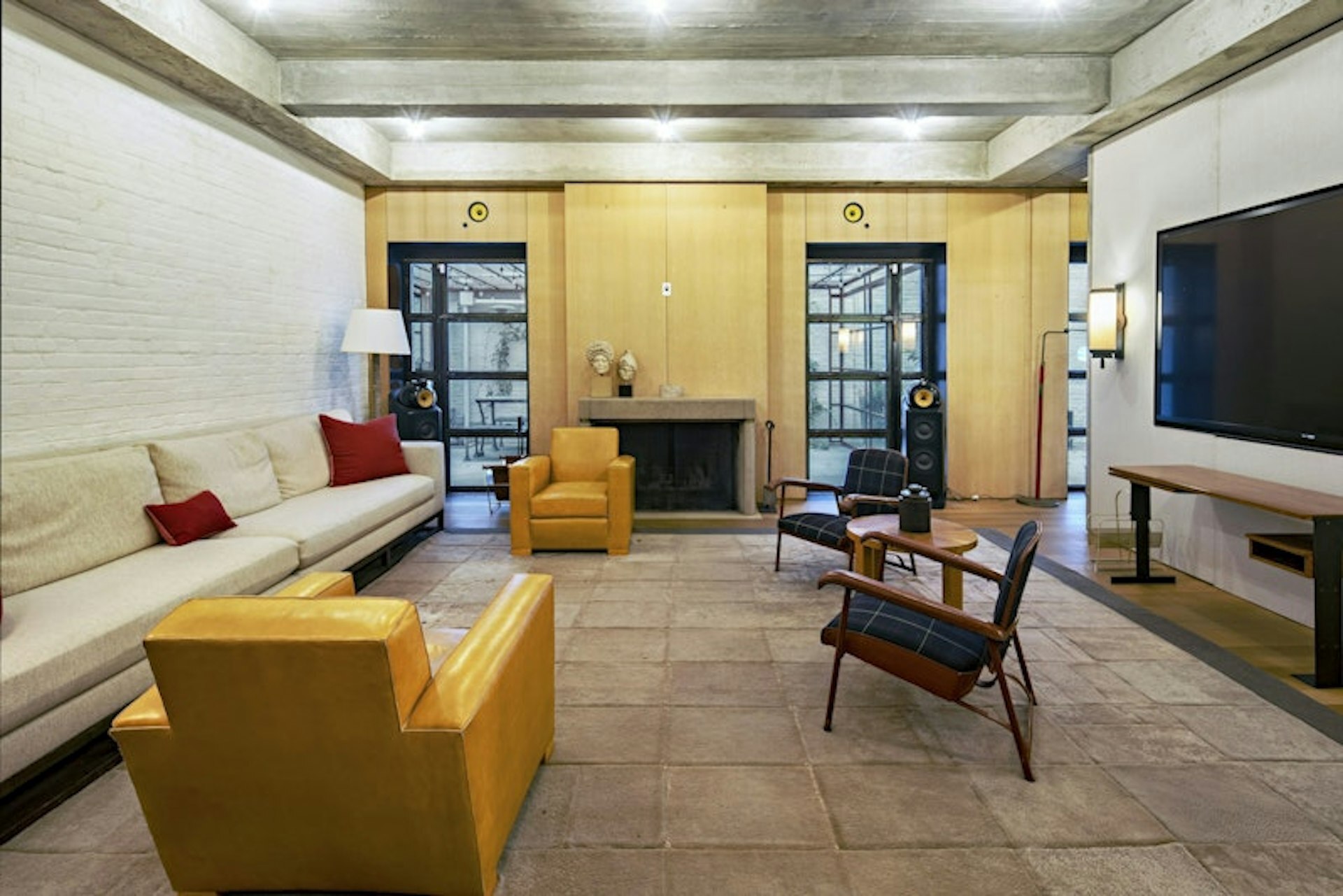36 East 63rd Street Manhattan, NY 10065 - Photo 6 of 21 a living room with furniture and a flat screen tv