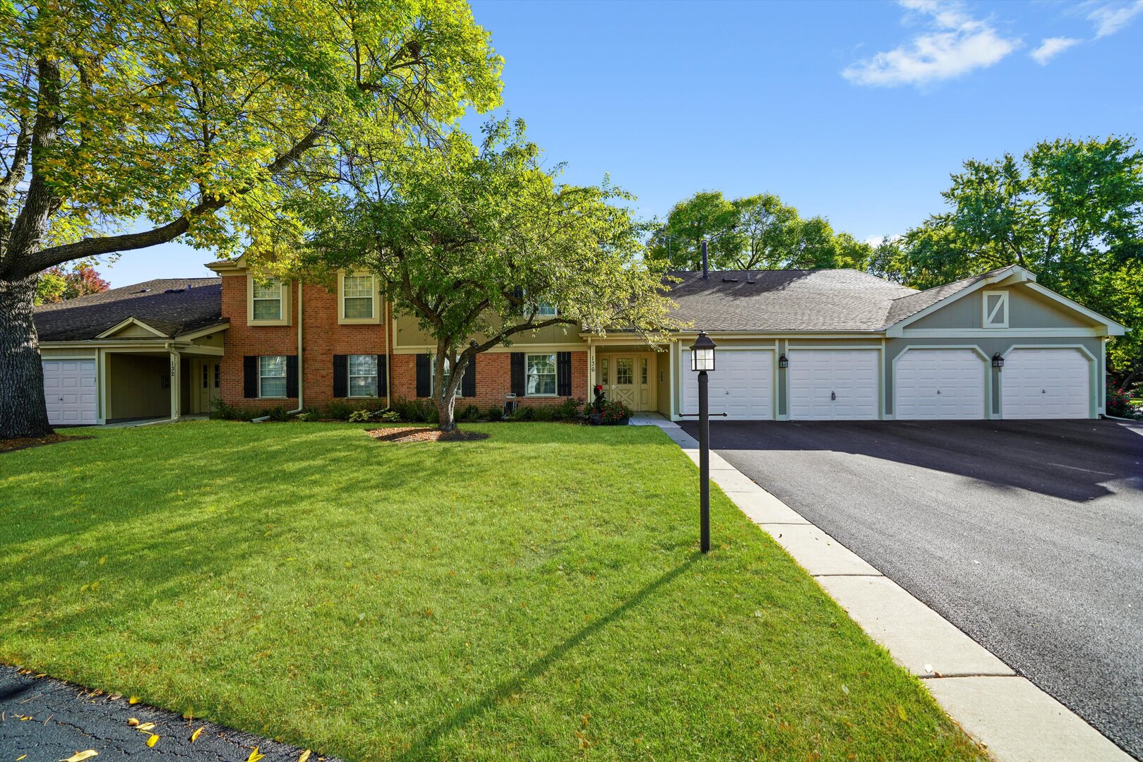136 Wolcott Court, Unit O2 Schaumburg, IL 60193 - Photo 1 of 31 a front view of a house with a garden and trees