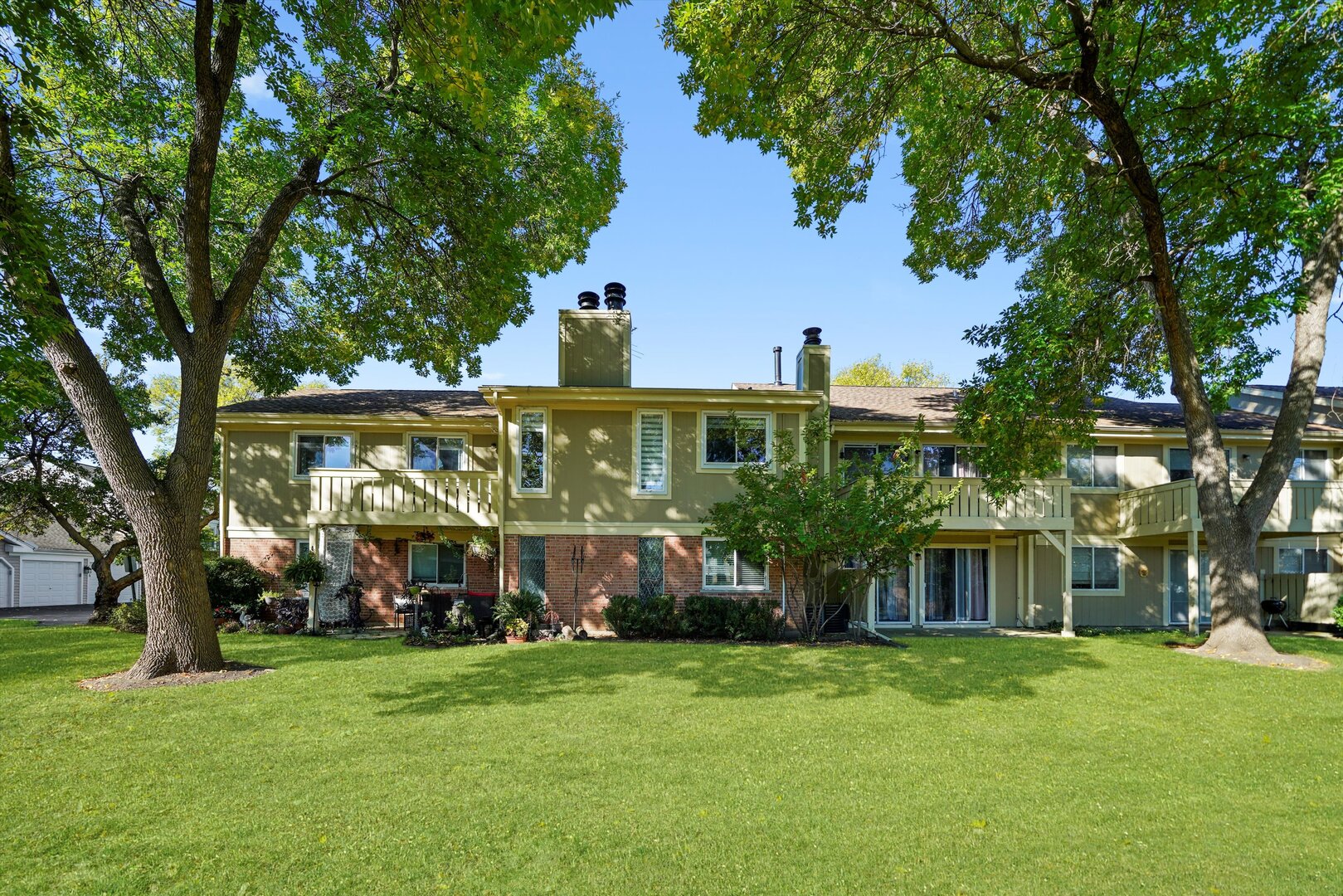 136 Wolcott Court, Unit O2 Schaumburg, IL 60193 - Photo 23 of 31 a front view of a house with a yard