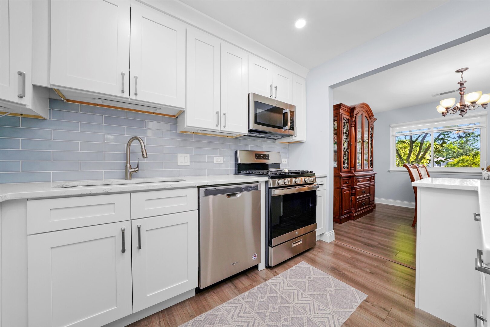 136 Wolcott Court, Unit O2 Schaumburg, IL 60193 - Photo 4 of 31 a kitchen with stainless steel appliances white cabinets and a sink