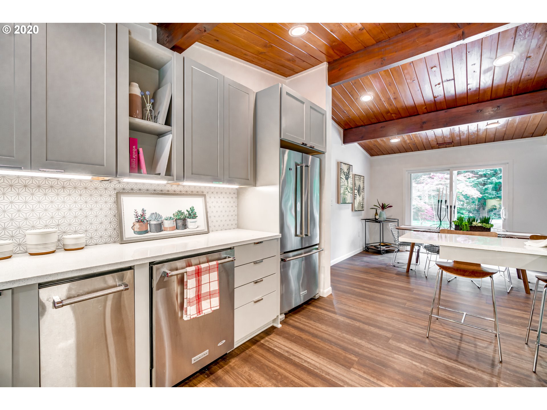 19971 South Ferguson Road Oregon City, OR 97045 - Photo 11 of 32 a open kitchen with stainless steel appliances granite countertop a refrigerator a sink dishwasher a dining table and chairs with wooden floor