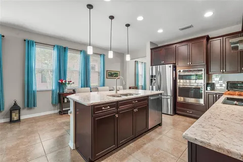 a kitchen with granite countertop stainless steel appliances and sink