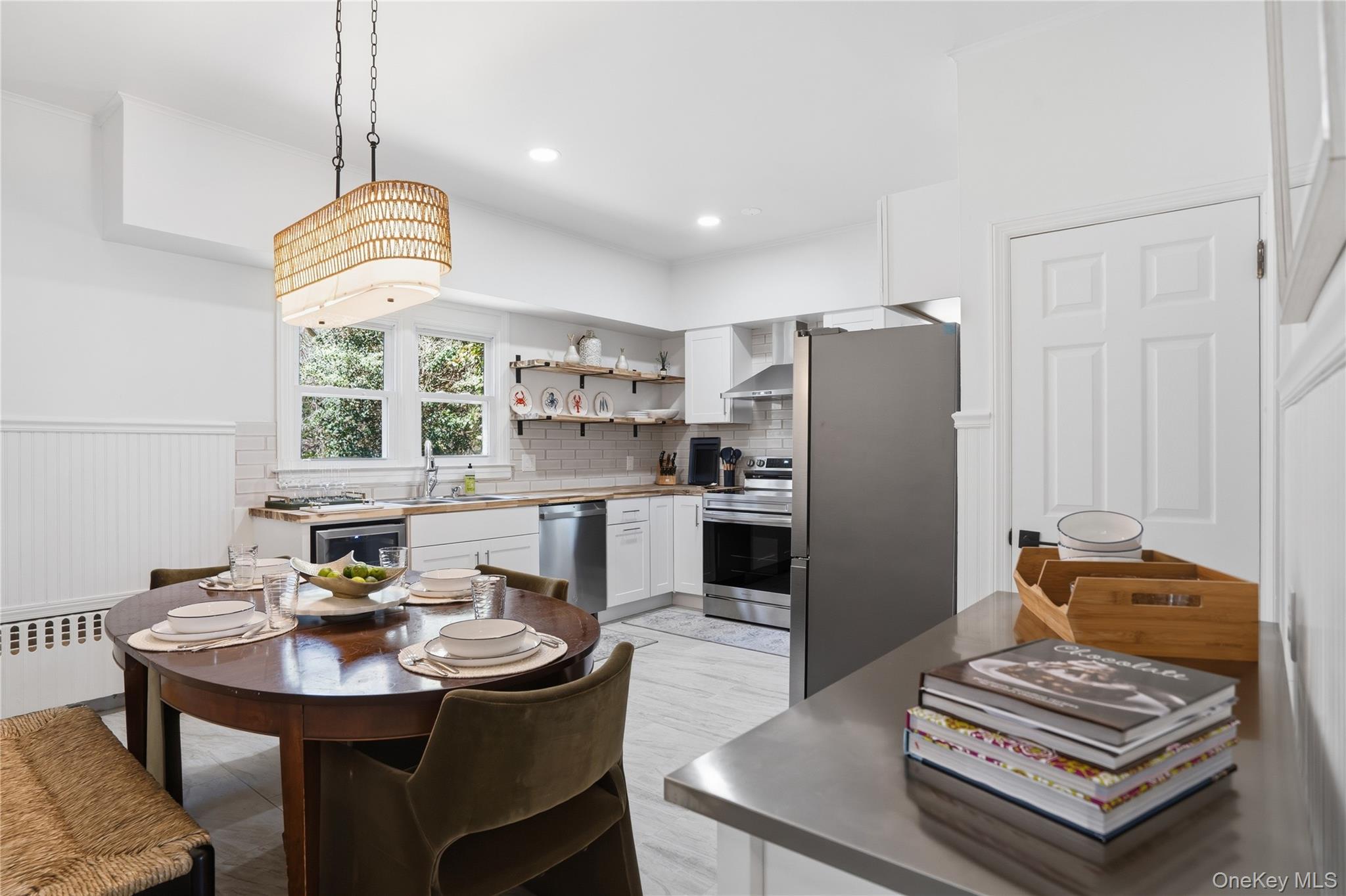 1550 Main Road Riverhead, NY 11901 - Photo 6 of 28 Modern kitchen featuring stainless steel appliances, white cabinetry, wood-finish countertops, open shelving, and a tile backsplash