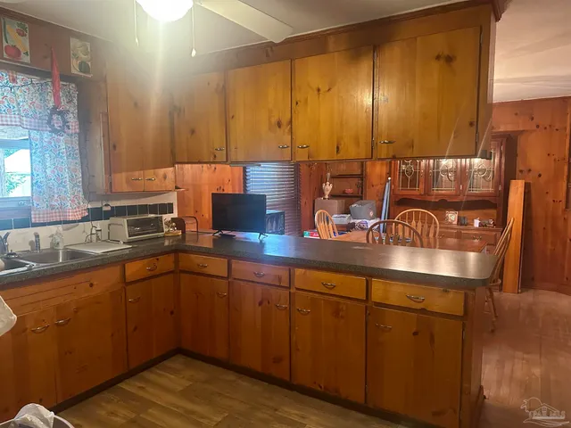 a kitchen with sink and cabinets