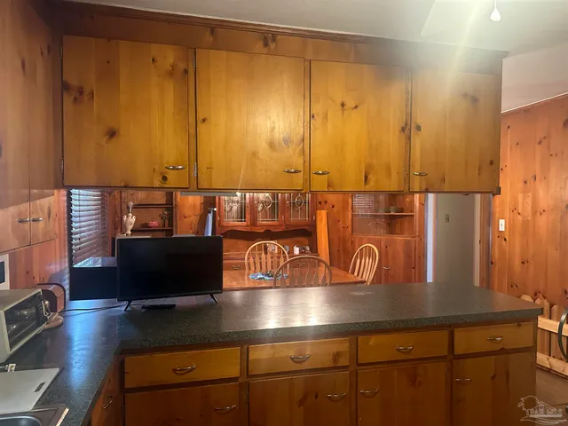 a view of kitchen with cabinets