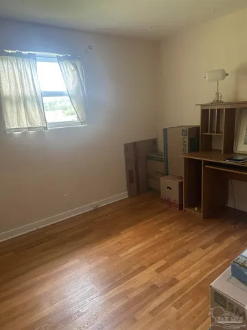 a room with wooden floor and furniture