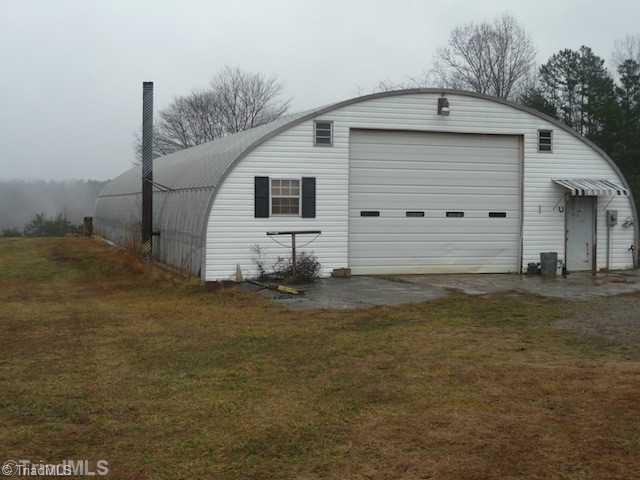 3074 Volunteer Road Pinnacle, NC 27043 - Photo 5 of 16 Stable/Barn. 40 x 100 - wired on separate meter and has a concrete floor - has large wood stove