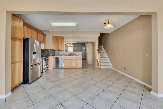 a kitchen with white cabinets and white appliances