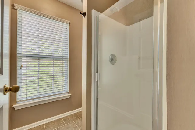 a view of a bathroom that has a window in it