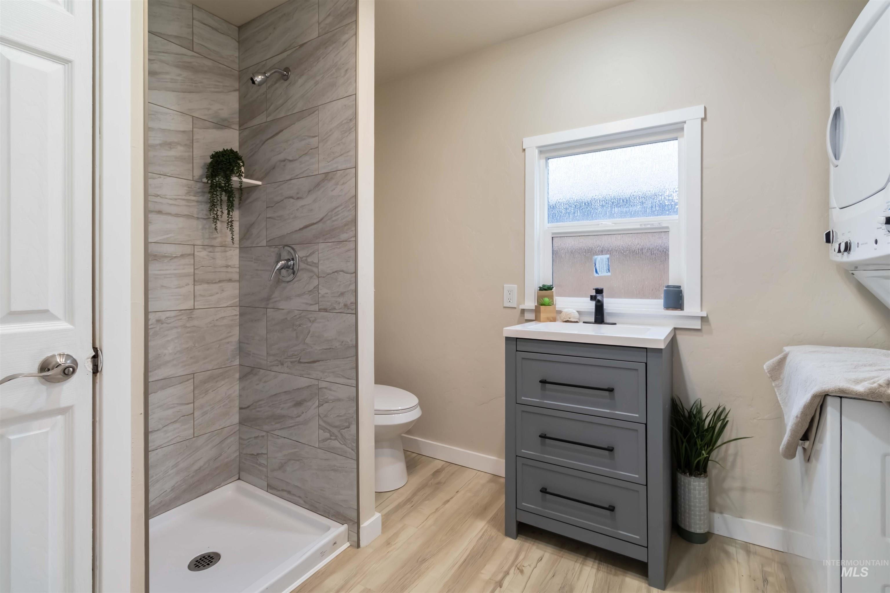 1012 East Main Street Weiser, ID 83672 - Photo 12 of 15 Bathroom with vanity, a stall shower, and light wood-style flooring