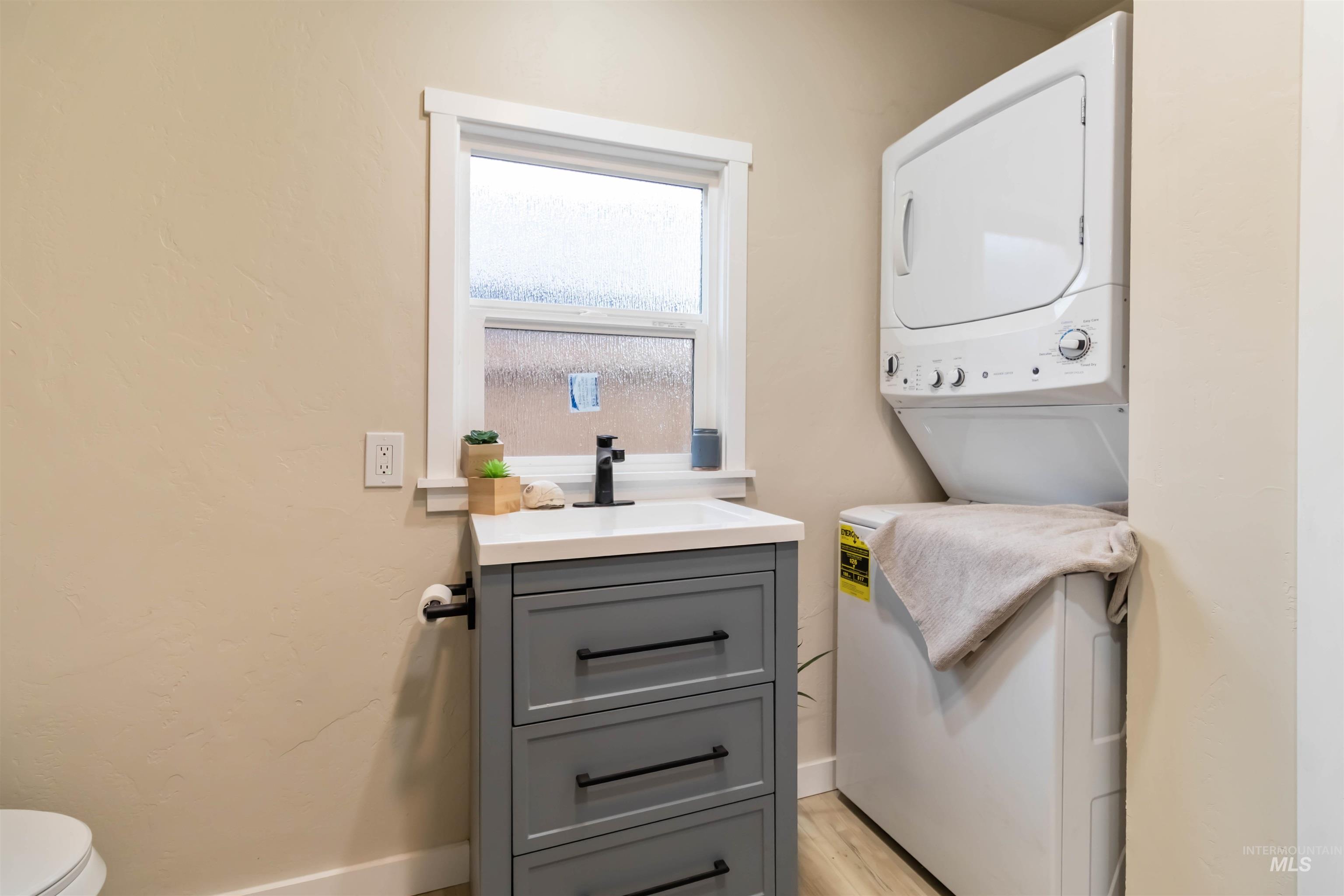 1012 East Main Street Weiser, ID 83672 - Photo 13 of 15 Laundry area with stacked washer / dryer and light wood finished floors