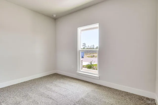 a view of an empty room and a window