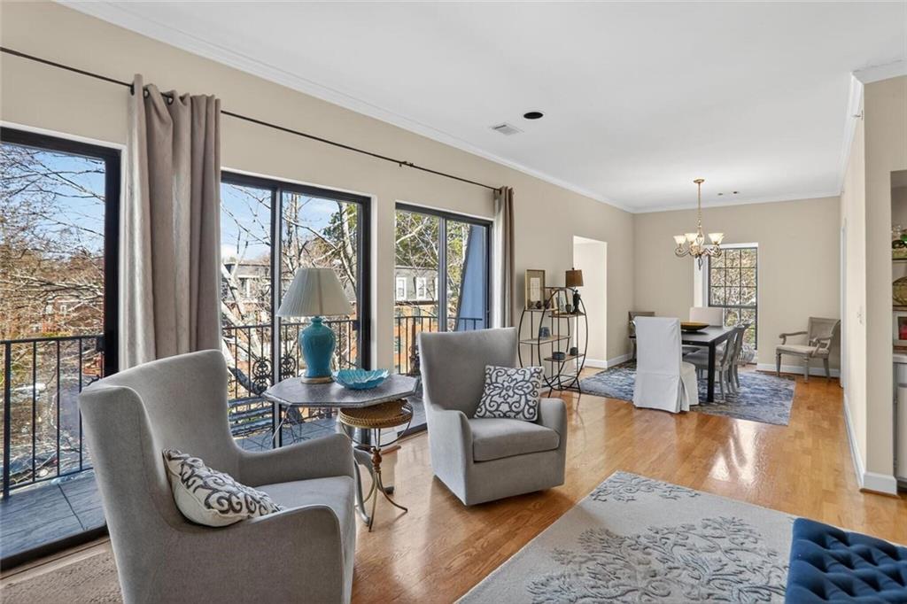 2921 Lenox Road Northeast, Unit 413 Atlanta, GA 30324 - Photo 1 of 36 a living room with furniture and a large window