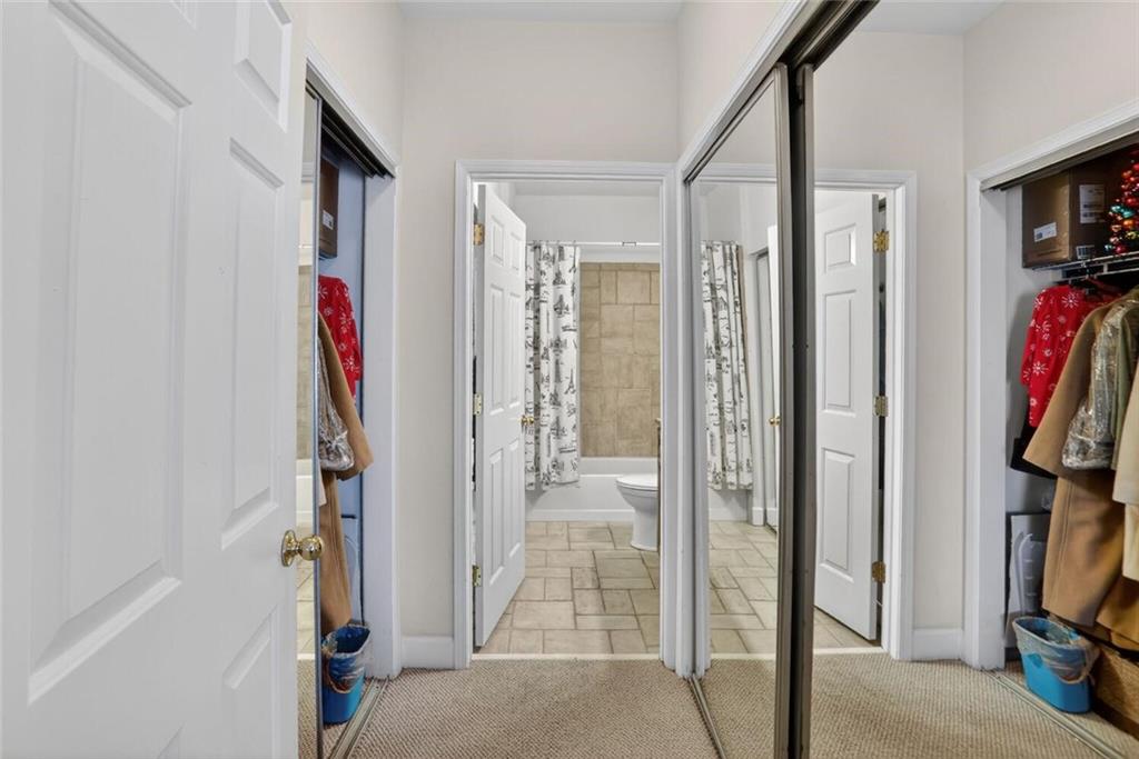2921 Lenox Road Northeast, Unit 413 Atlanta, GA 30324 - Photo 12 of 36 a view of walk in closet with clothes and shoes