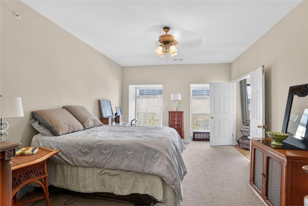 2921 Lenox Road Northeast, Unit 413 Atlanta, GA 30324 - Photo 17 of 36 a bedroom with a bed and a flat screen tv