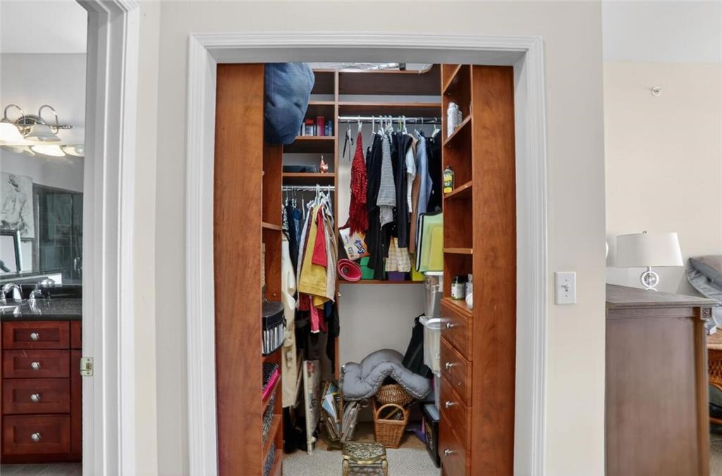 2921 Lenox Road Northeast, Unit 413 Atlanta, GA 30324 - Photo 18 of 36 a view of walk in closet with clothes