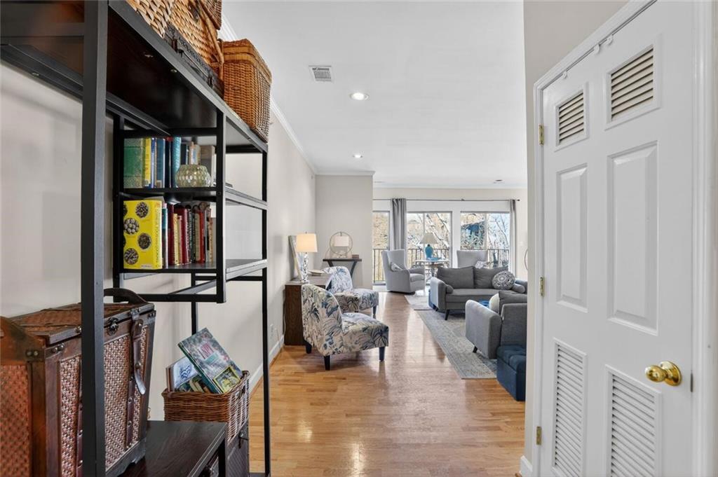 2921 Lenox Road Northeast, Unit 413 Atlanta, GA 30324 - Photo 2 of 36 a living room with fireplace furniture and a floor to ceiling window