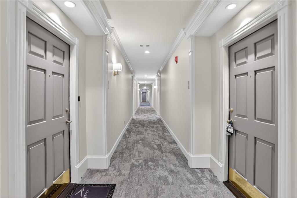 2921 Lenox Road Northeast, Unit 413 Atlanta, GA 30324 - Photo 31 of 36 a view of a hallway with a white walls and stairs