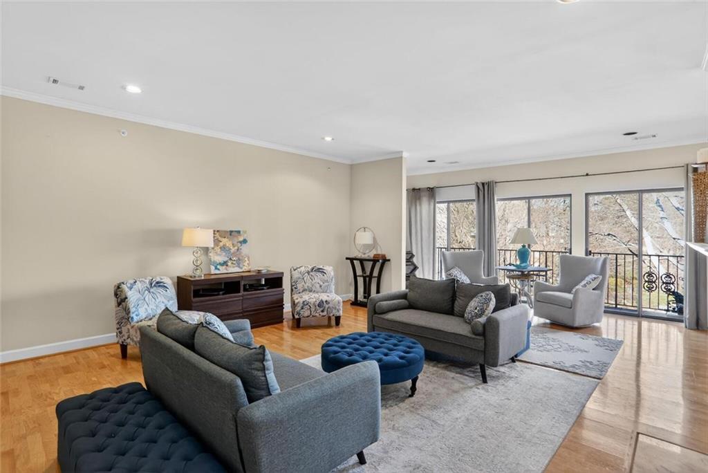 2921 Lenox Road Northeast, Unit 413 Atlanta, GA 30324 - Photo 4 of 36 a living room with furniture and a large window