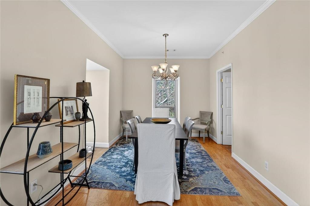 2921 Lenox Road Northeast, Unit 413 Atlanta, GA 30324 - Photo 8 of 36 a living room with furniture and a chandelier