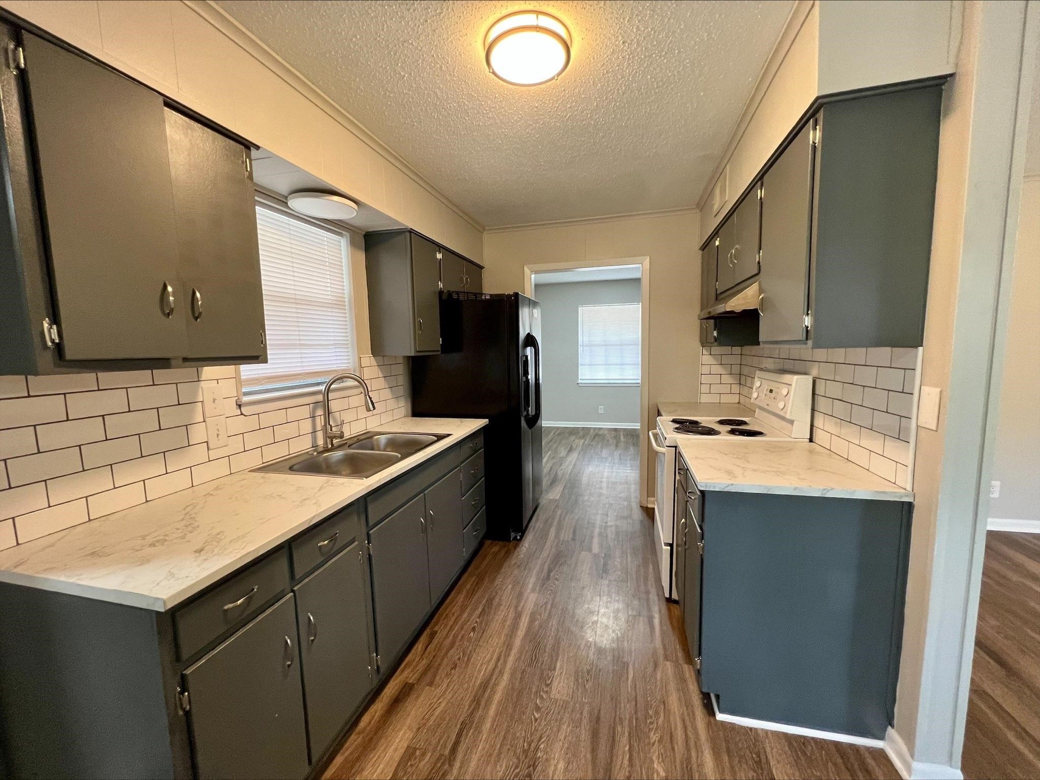 3831 Millbranch Road Memphis, TN 38116 - Photo 2 of 12 a kitchen with stainless steel appliances granite countertop a sink stove and refrigerator