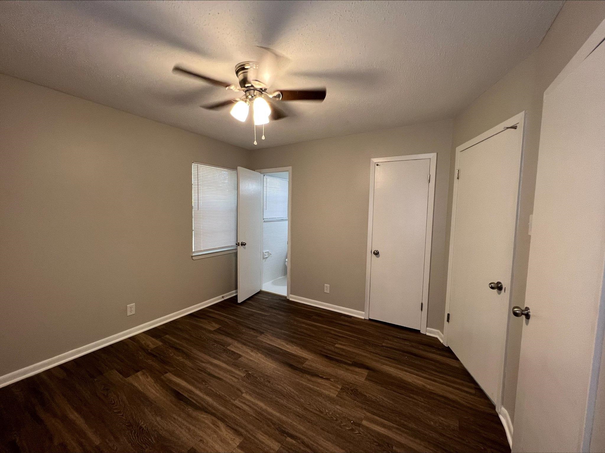 3831 Millbranch Road Memphis, TN 38116 - Photo 5 of 12 a view of an empty room with wooden floor
