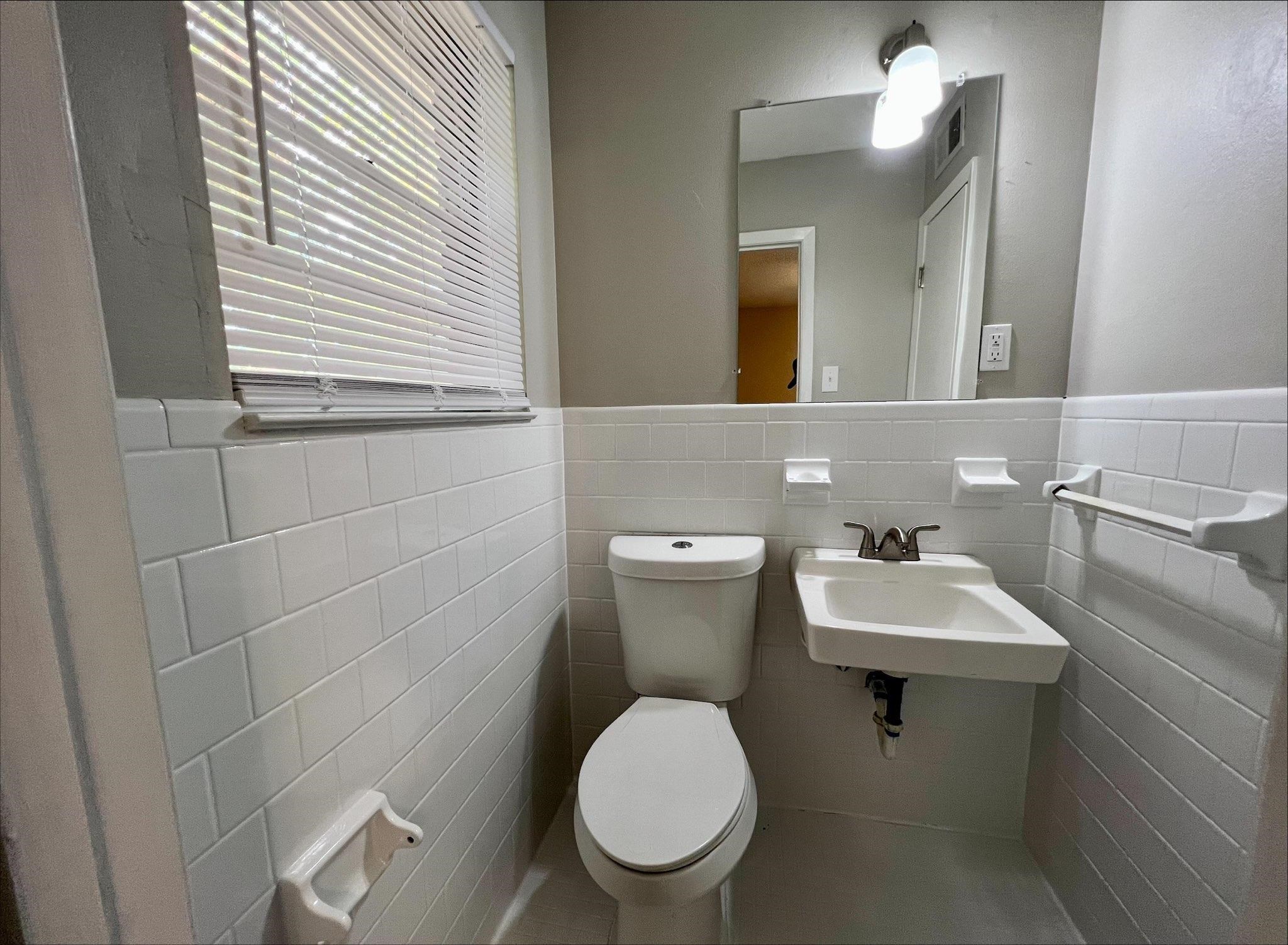 3831 Millbranch Road Memphis, TN 38116 - Photo 6 of 12 a bathroom with a toilet sink and mirror