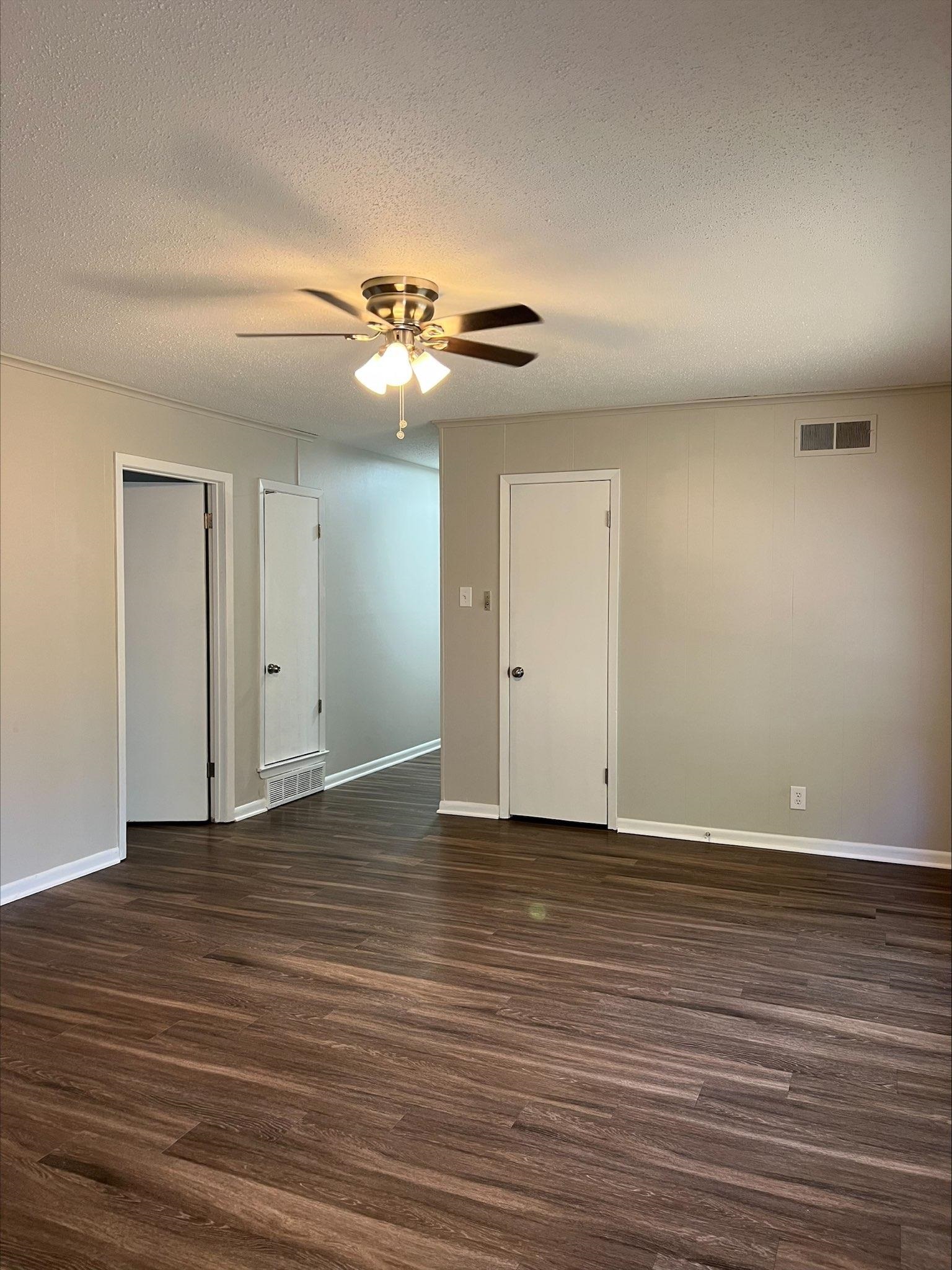 3831 Millbranch Road Memphis, TN 38116 - Photo 7 of 12 a view of an empty room with wooden floor