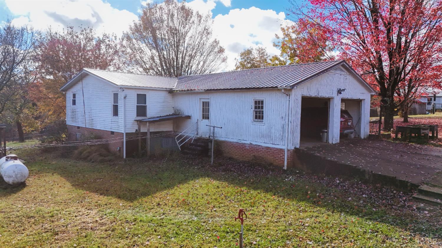 3156 Owens Mill Road Gretna, VA 24557 - Photo 32 of 88 a backyard of a house with table and chairs