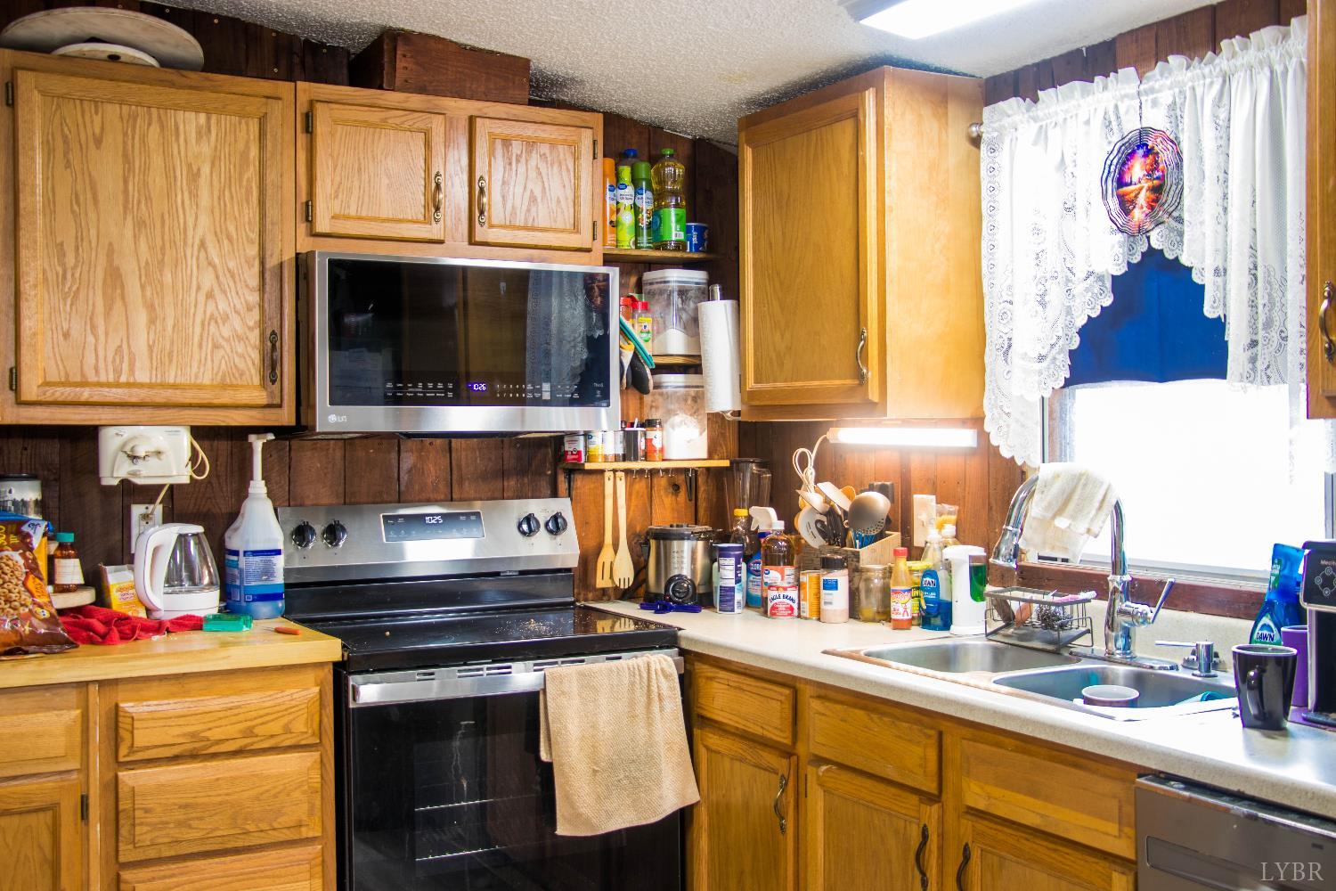3156 Owens Mill Road Gretna, VA 24557 - Photo 78 of 88 a kitchen with a stove a sink and a microwave