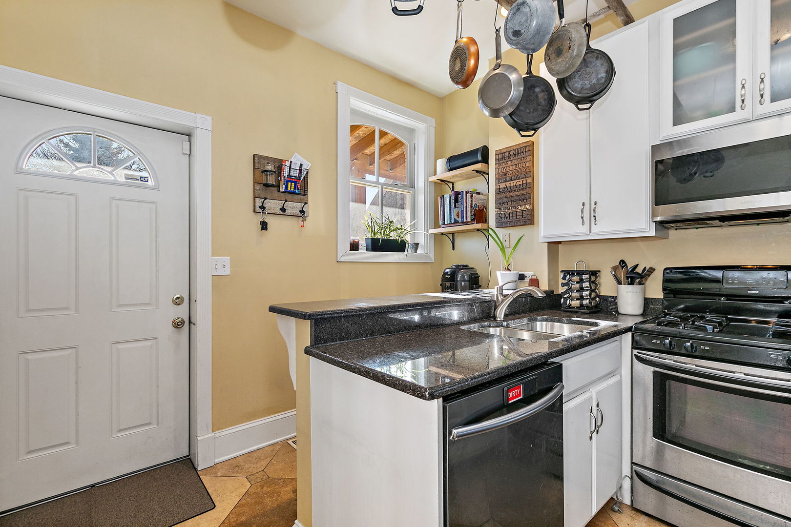 271 Dupage Street Elgin, IL 60120 - Photo 9 of 27 a kitchen with stainless steel appliances granite countertop a sink and stove top oven