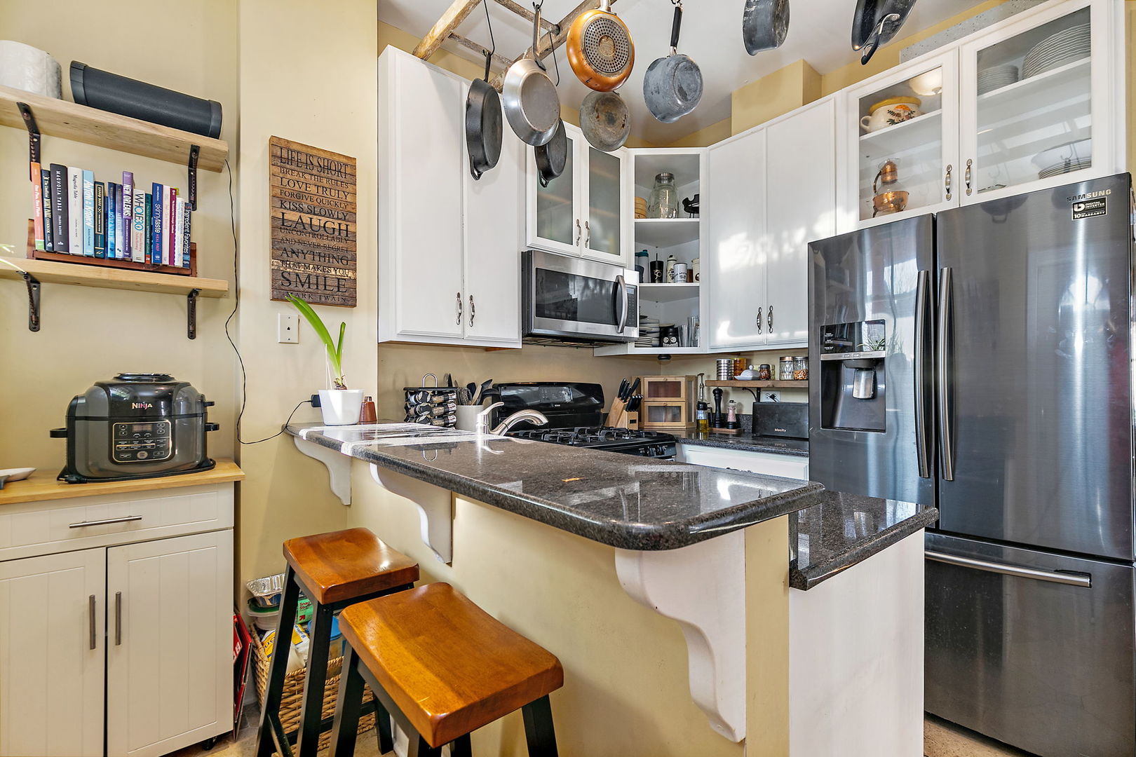 271 Dupage Street Elgin, IL 60120 - Photo 10 of 27 a kitchen with stainless steel appliances granite countertop a refrigerator a stove and a sink with wooden floor