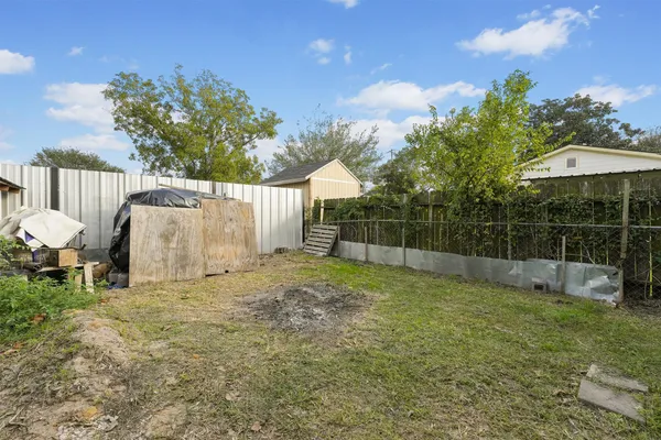 a view of a backyard with a garden and entertaining space