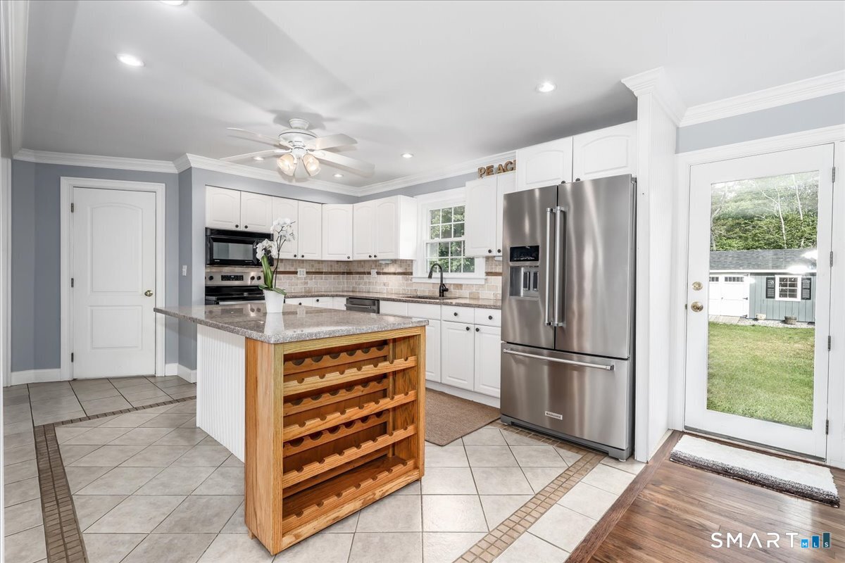 19 Botsford Hill Road Newtown, CT 06470 - Photo 8 of 40 a kitchen with stainless steel appliances a refrigerator sink and microwave