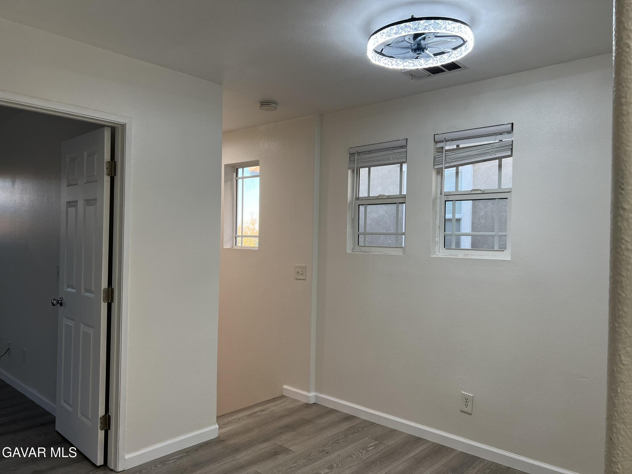 2649 Torres Court Palmdale, CA 93550 - Photo 15 of 33 an empty room with wooden floor and windows