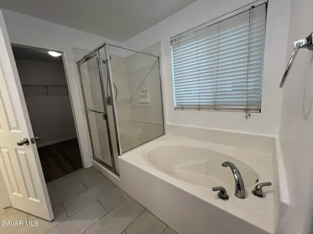 a bathroom with a tub and a shower
