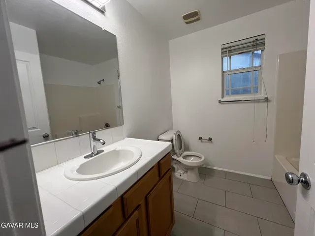 a bathroom with a sink toilet and vanity