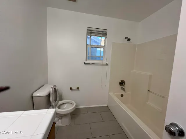 a bathroom with a toilet a sink and bathtub