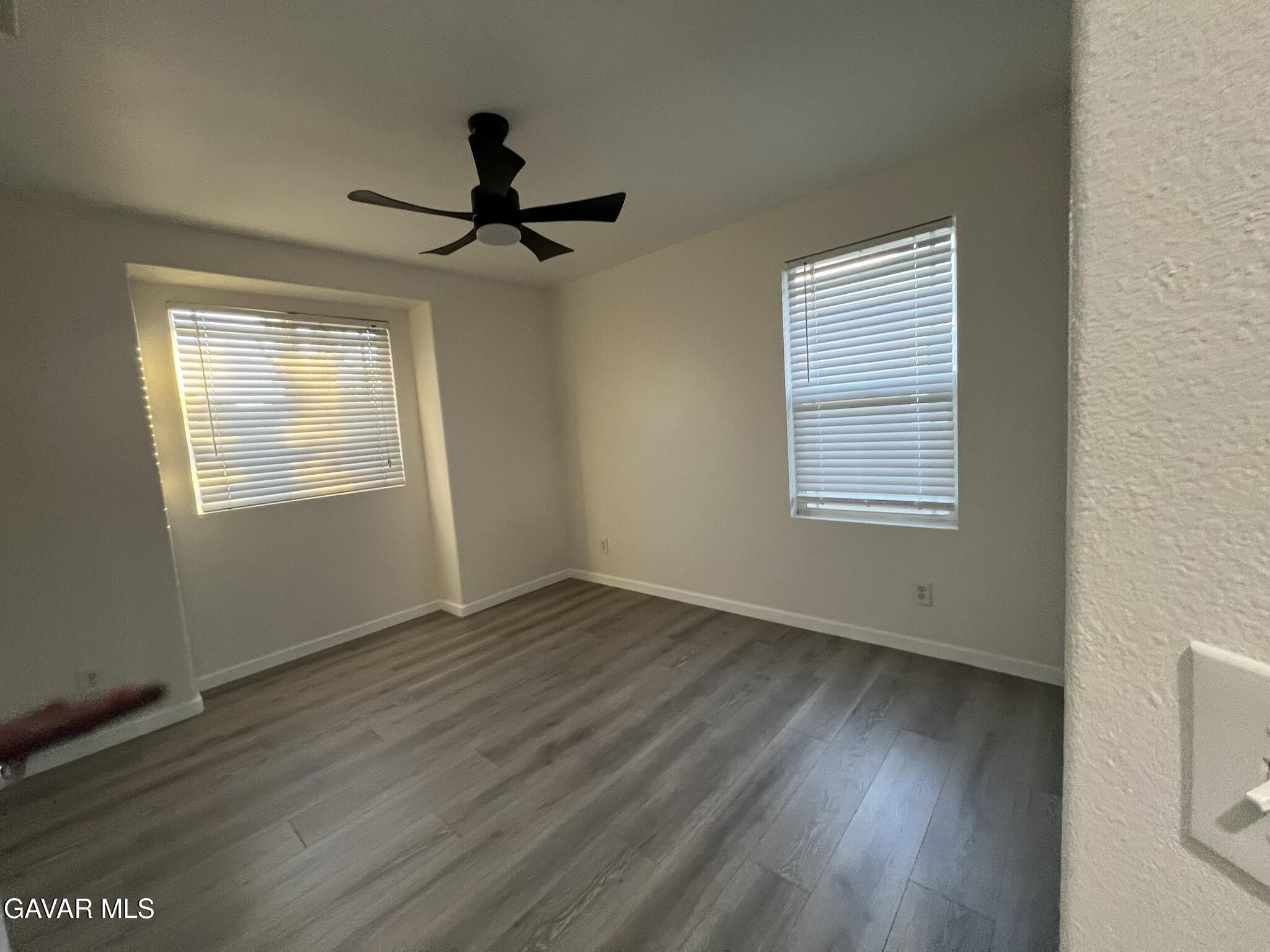 2649 Torres Court Palmdale, CA 93550 - Photo 30 of 33 a view of an empty room with wooden floor and a window