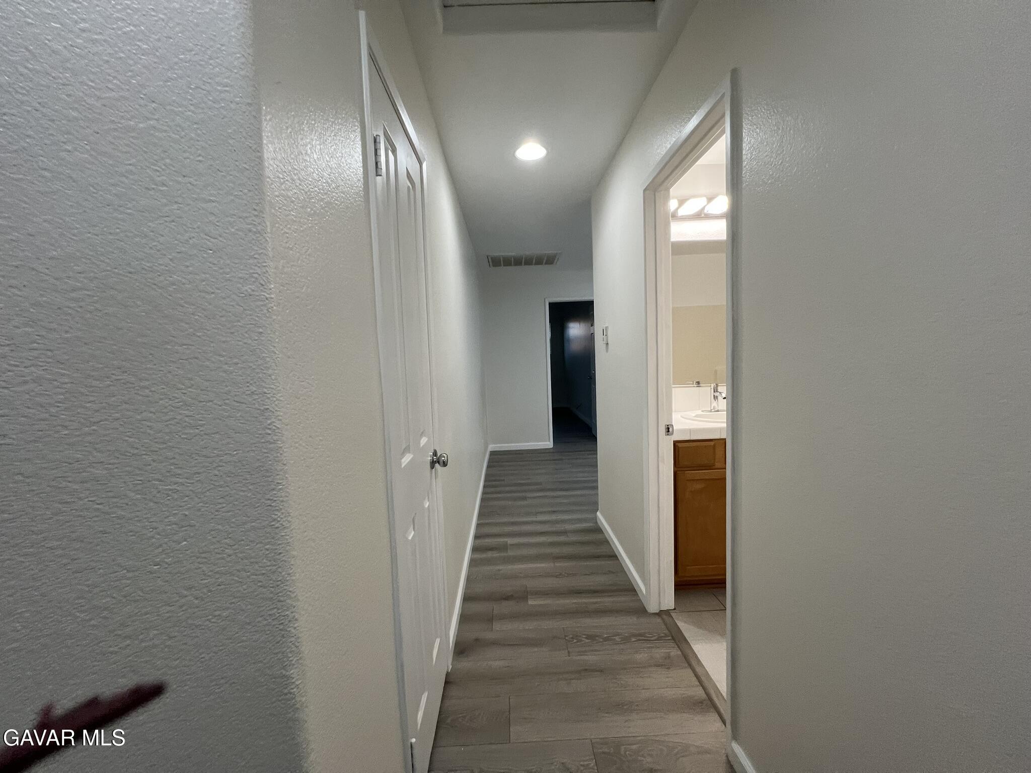 2649 Torres Court Palmdale, CA 93550 - Photo 33 of 33 a view of a hallway with wooden floor
