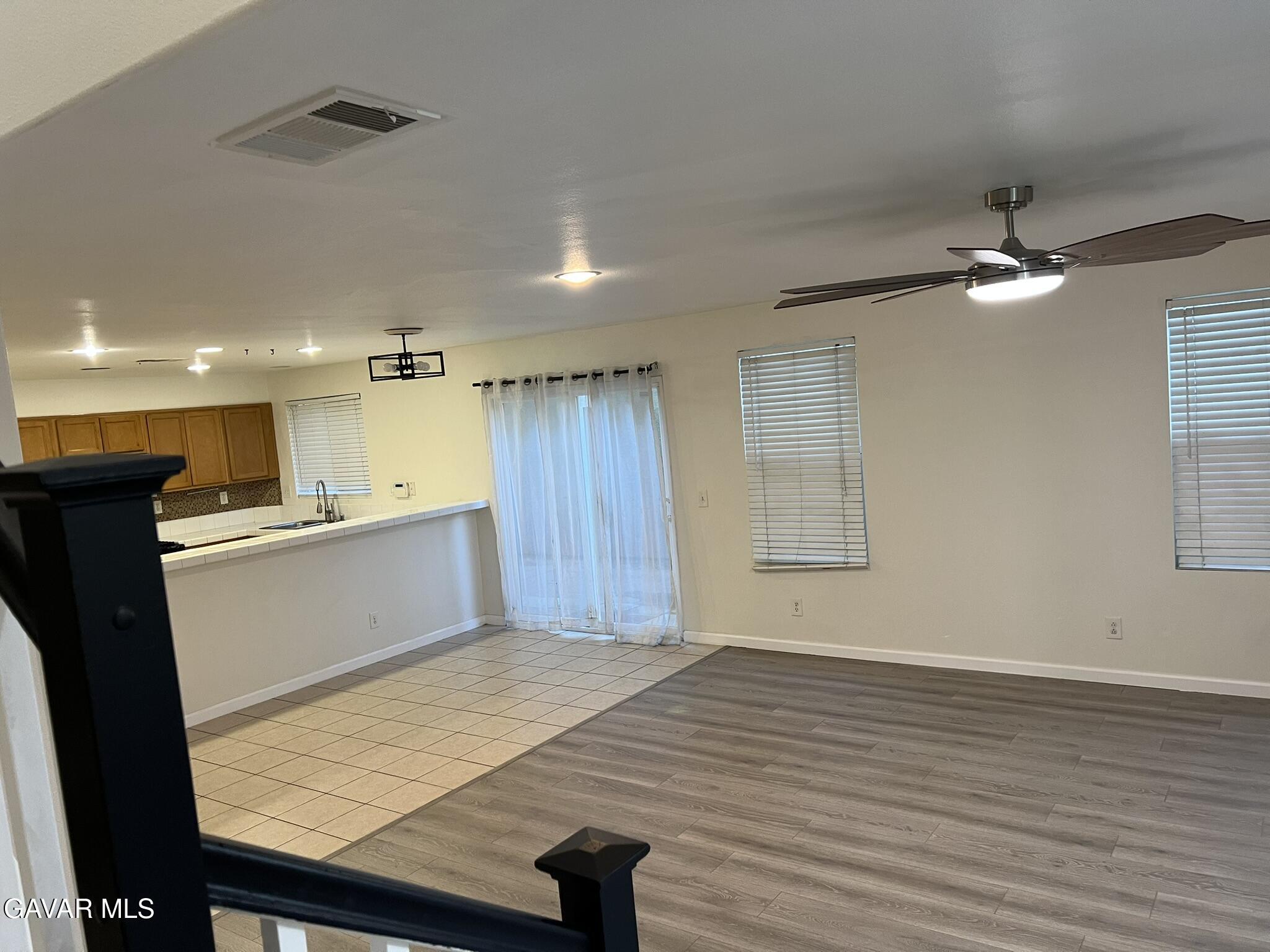 2649 Torres Court Palmdale, CA 93550 - Photo 9 of 33 an empty room with wooden floor and windows