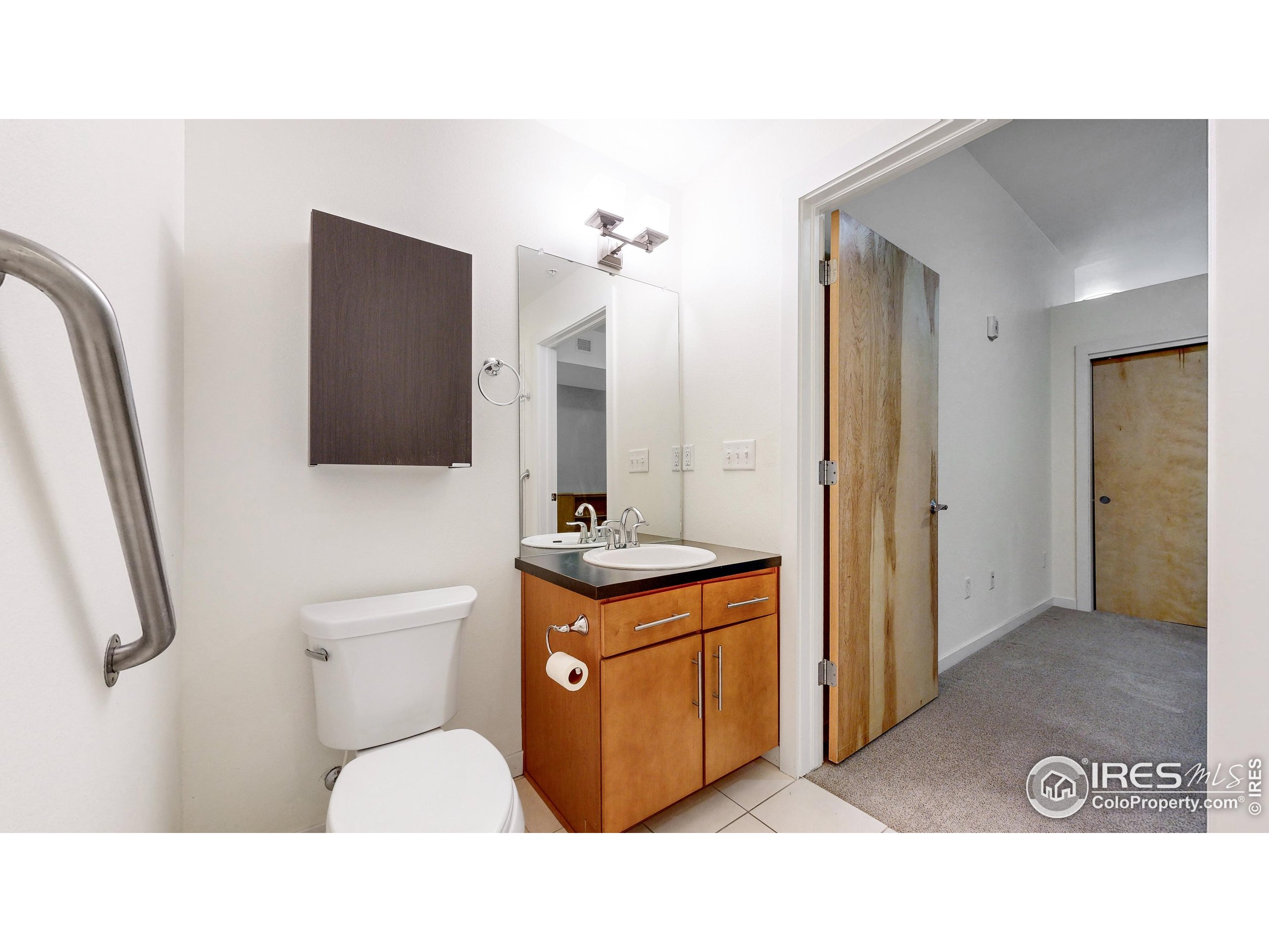 204 Maple Street, Unit 403 Fort Collins, CO 80521 - Photo 11 of 31 a bathroom with a toilet sink shower and mirror