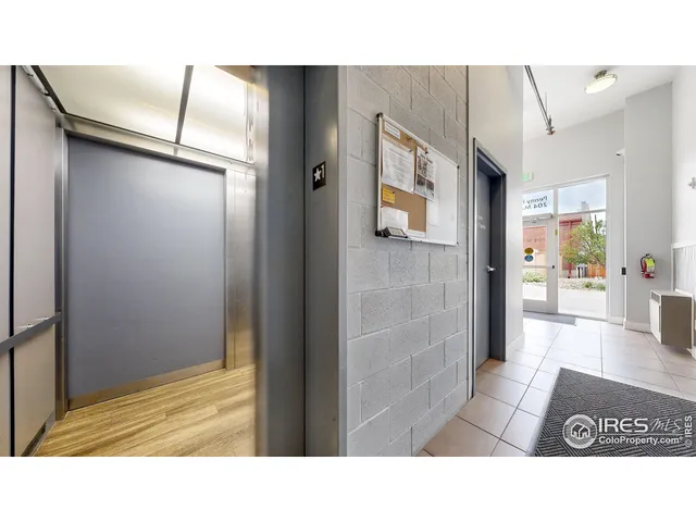 a couple of cars parked in front of a building