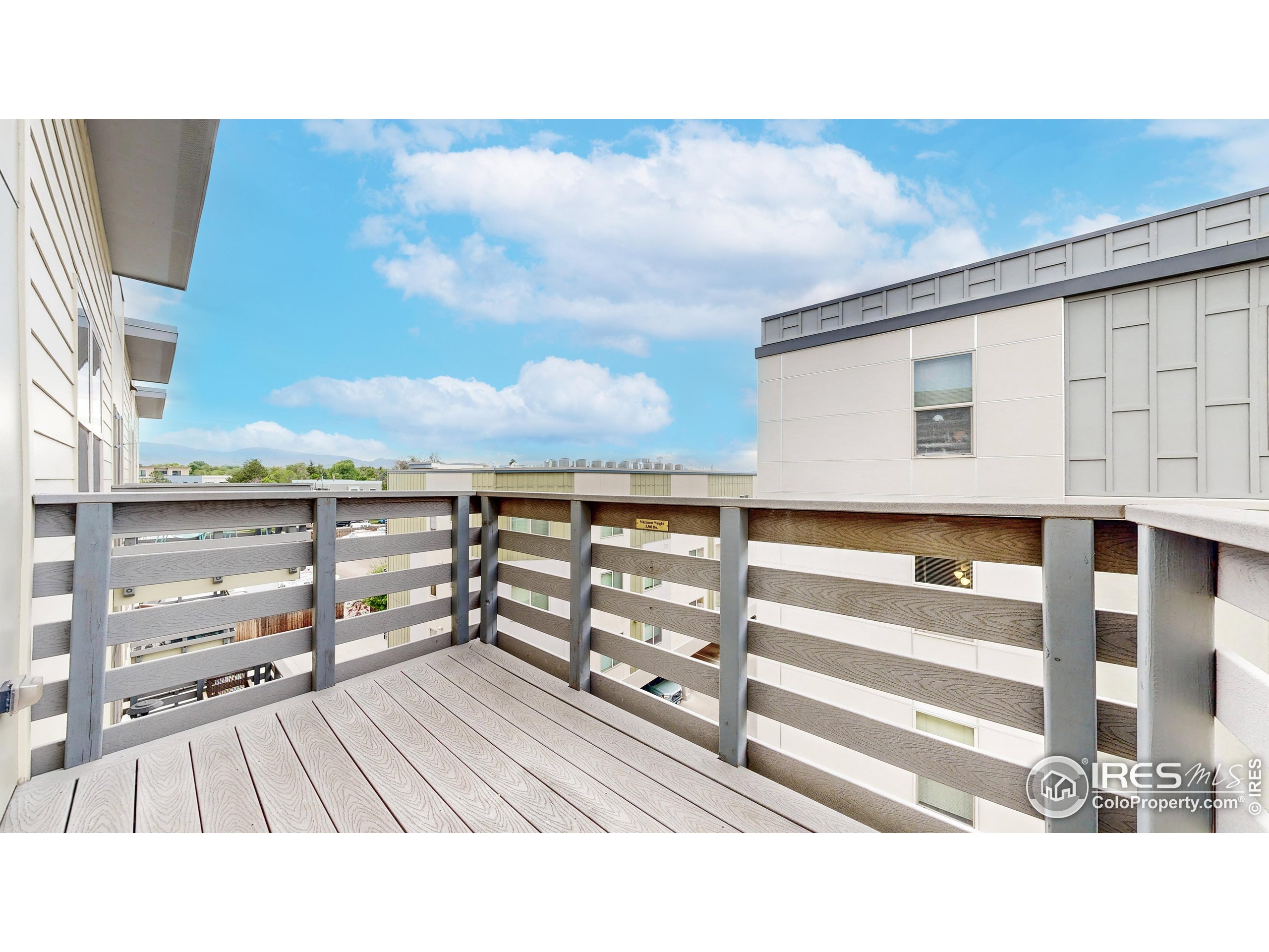 204 Maple Street, Unit 403 Fort Collins, CO 80521 - Photo 25 of 31 a view of a balcony with wooden floor and city view