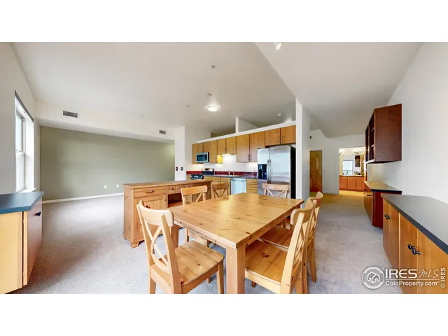 a dining room with furniture and a window