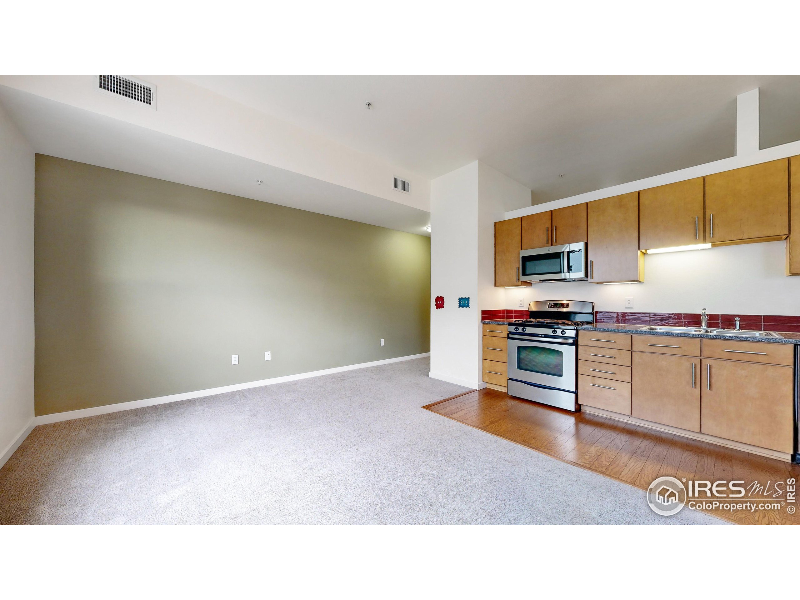 204 Maple Street, Unit 403 Fort Collins, CO 80521 - Photo 8 of 31 a kitchen with kitchen island sink and stove